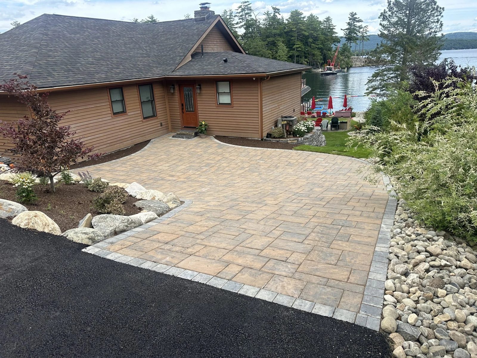 Cambridge paver driveway with a boulder border at a Lake George lakefront home
